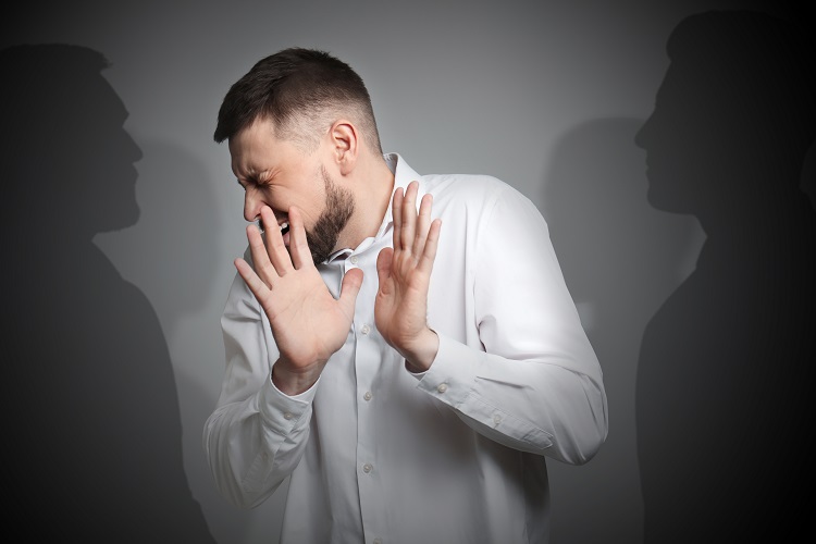 The man closes his eyes and is afraid, there are shadows around him, indicating that he is feeling hallucinations that are a side effect of kratom